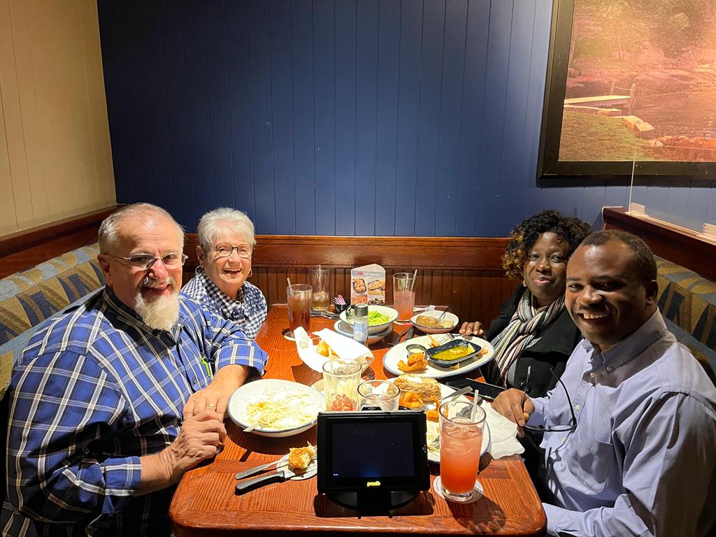 John & Marie Gage with John & Buki Agboola dining out.